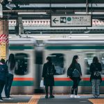 Traveler with luggage at a Japanese train station