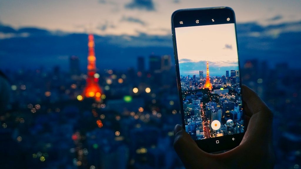 Traveler using a smartphone in Japan while exploring Tokyo