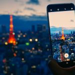 Traveler using a smartphone in Japan while exploring Tokyo