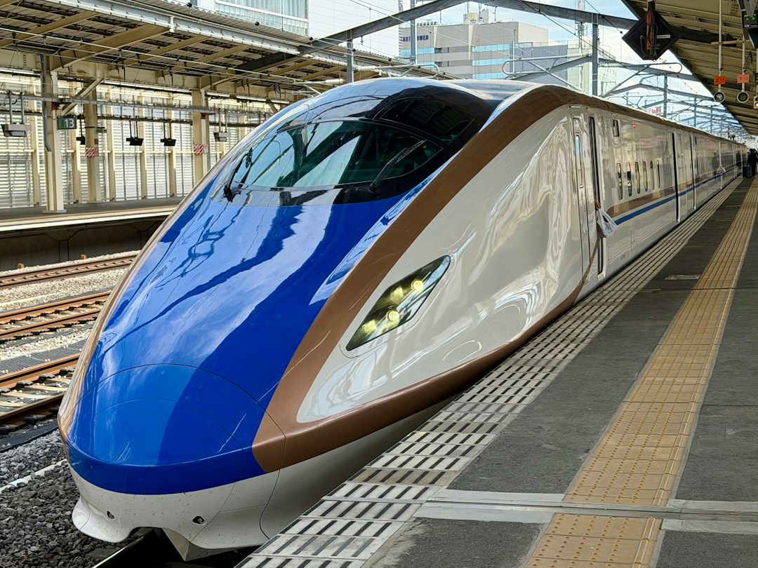 Shinkansen bullet train at a Japanese railway station, illustrating long-distance rail travel in Japan